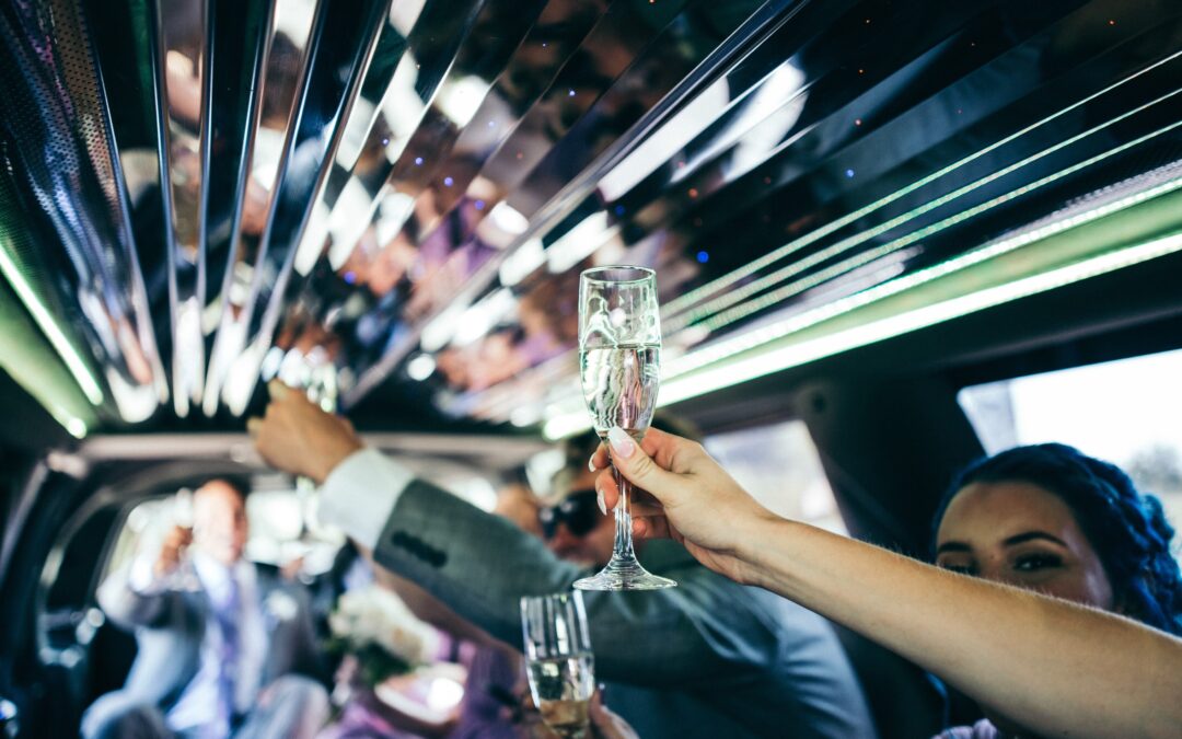 People cheers-ing with champagne on party limo