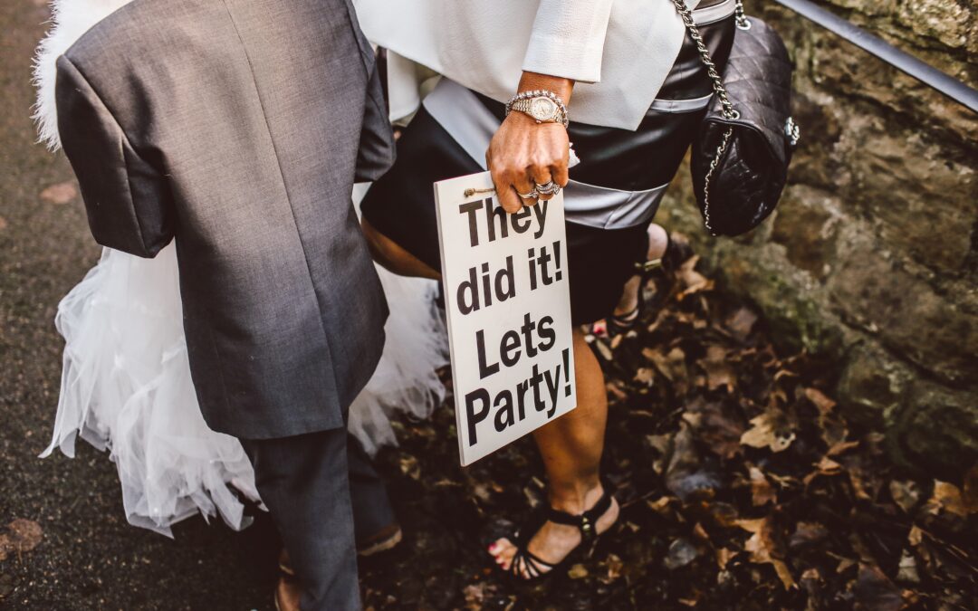 Couple holding wedding sign